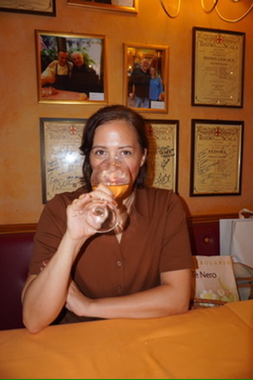 Ally tasting a glass of white wine